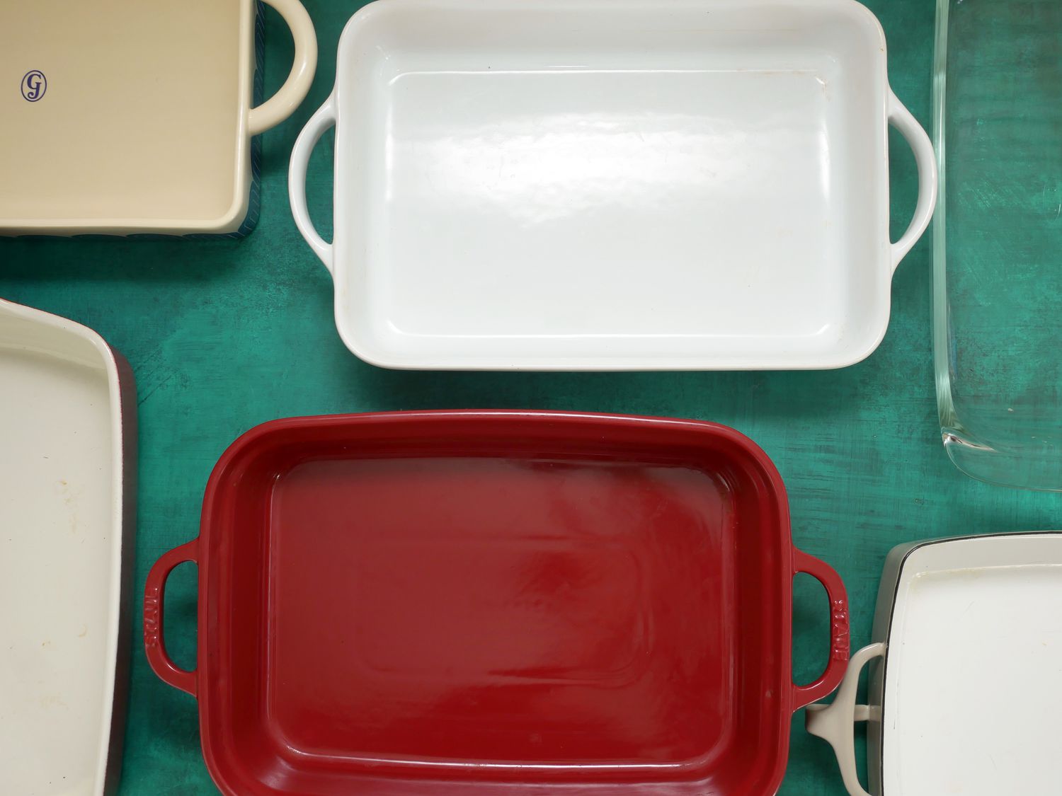 Group of casserole dishes displayed on a green surface