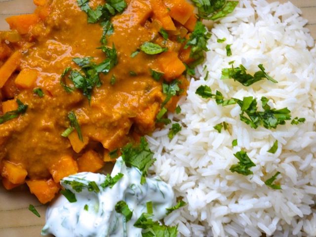 British curry sauce mixed with vegetables and served with white rice and parsley garnish