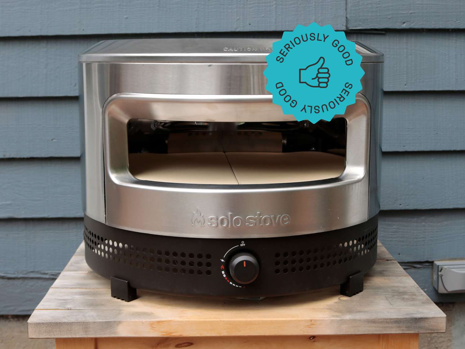 solo stove pi prime pizza oven on a wooden table