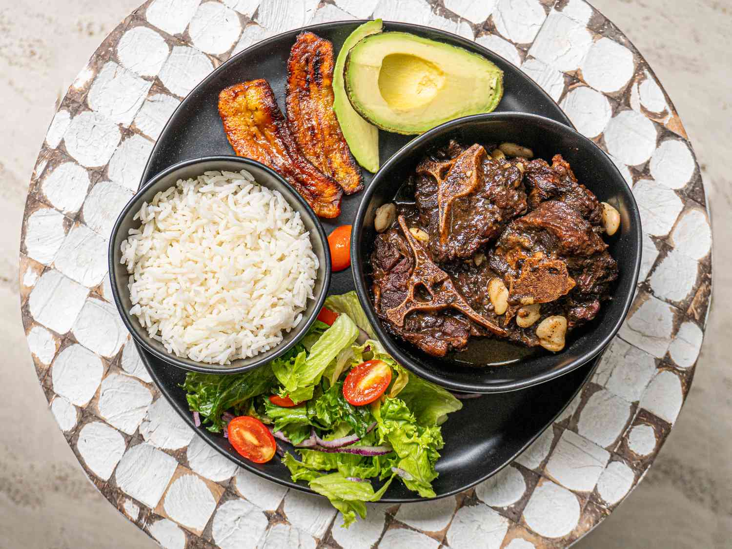 Overhead view of Jmaican oxtail on a platter