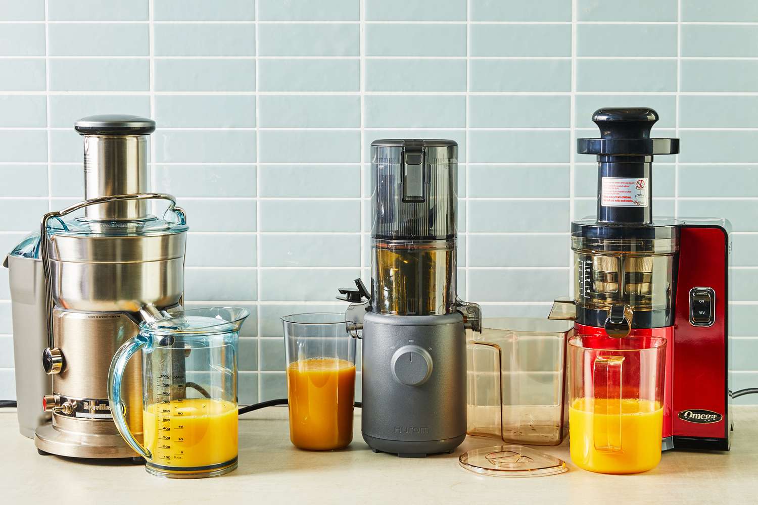 Three juicers on a kitchen countertop.