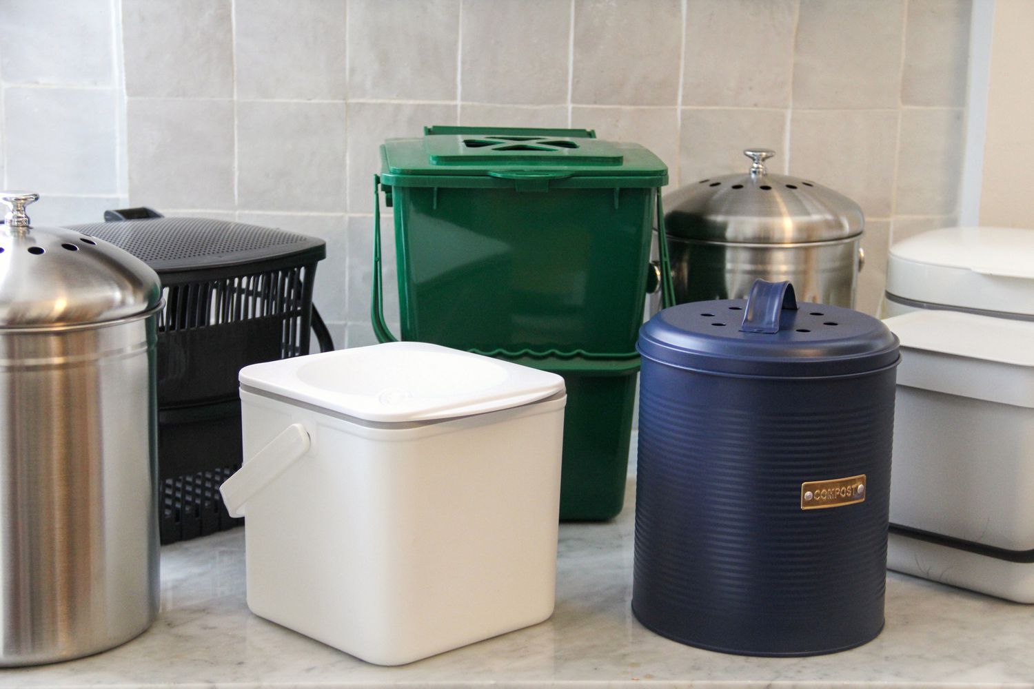 A collection of compost bins on a marble countertop