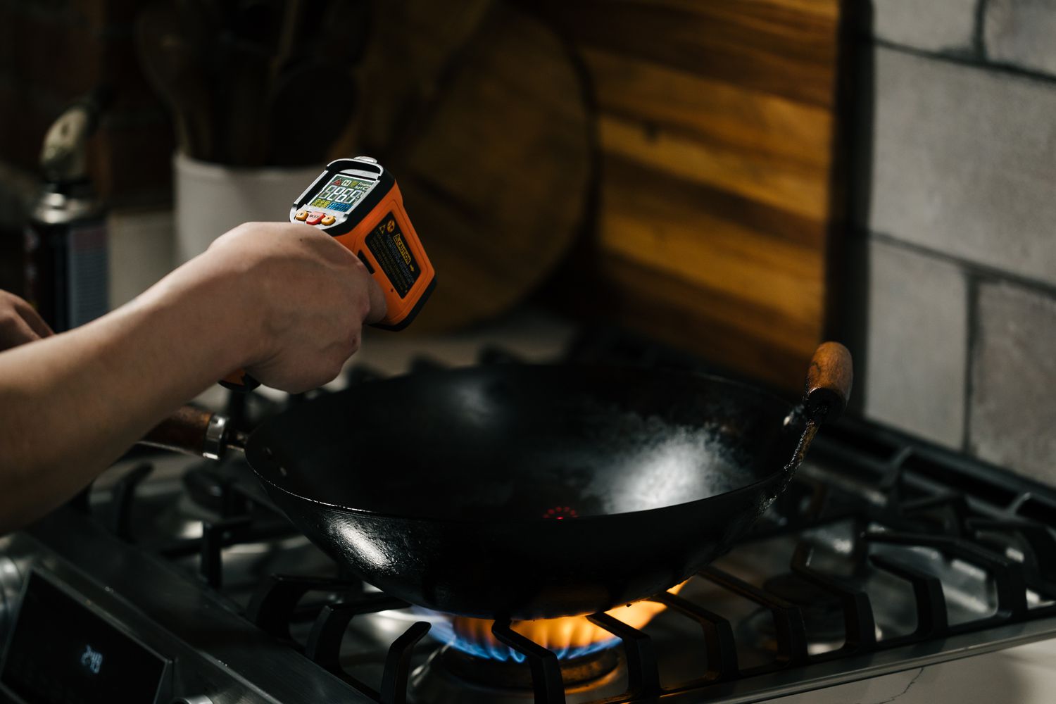 A thermometer pointed at a wok