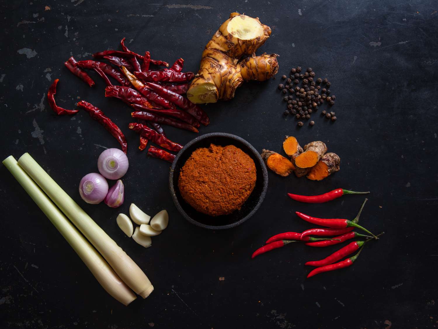 Prik Gaeng Pak Dtai (Southern Thai Curry Paste) with ingredients scattered around