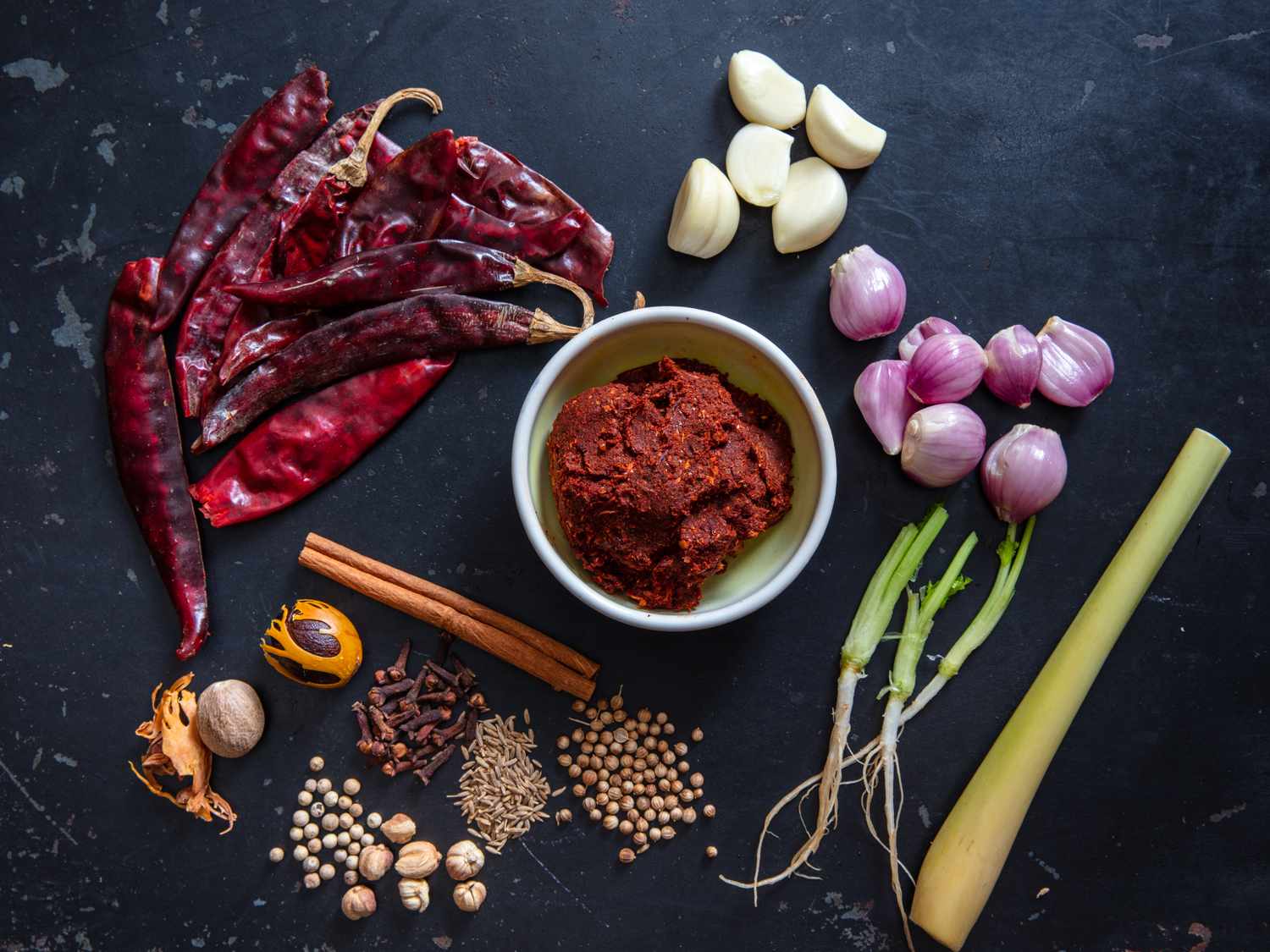 massaman curry paste with ingredients surrounding it 