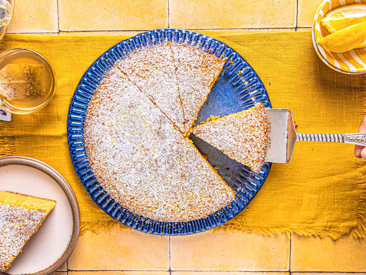 Overhead view of lemon ricotta cake being slices