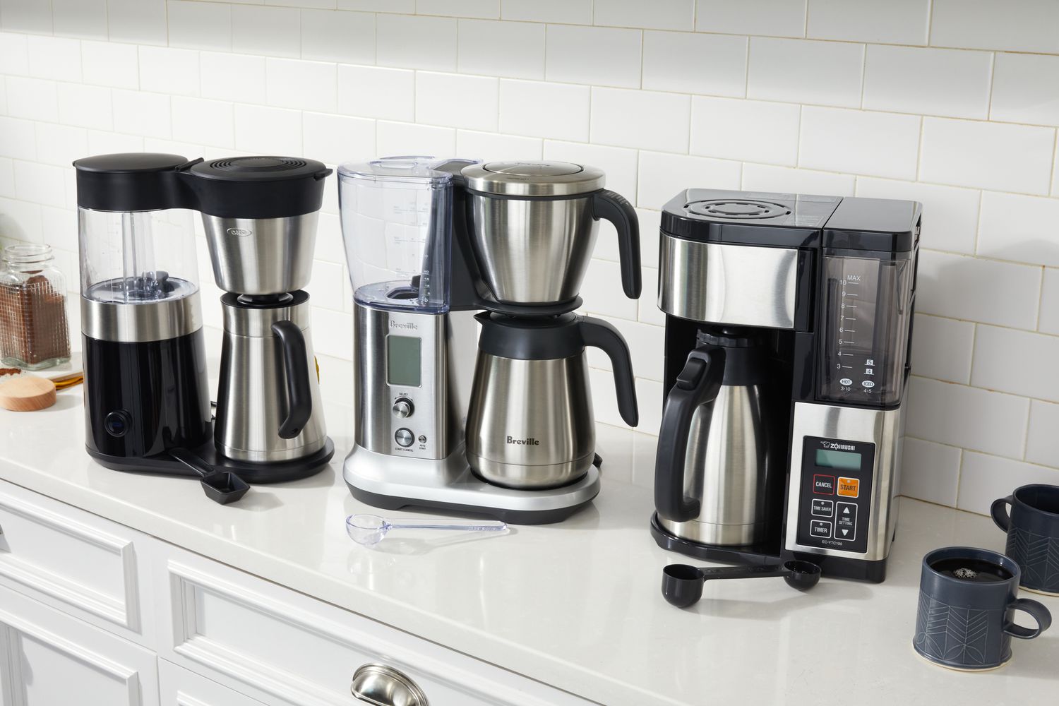 three coffee makers on a kitchen countertop 