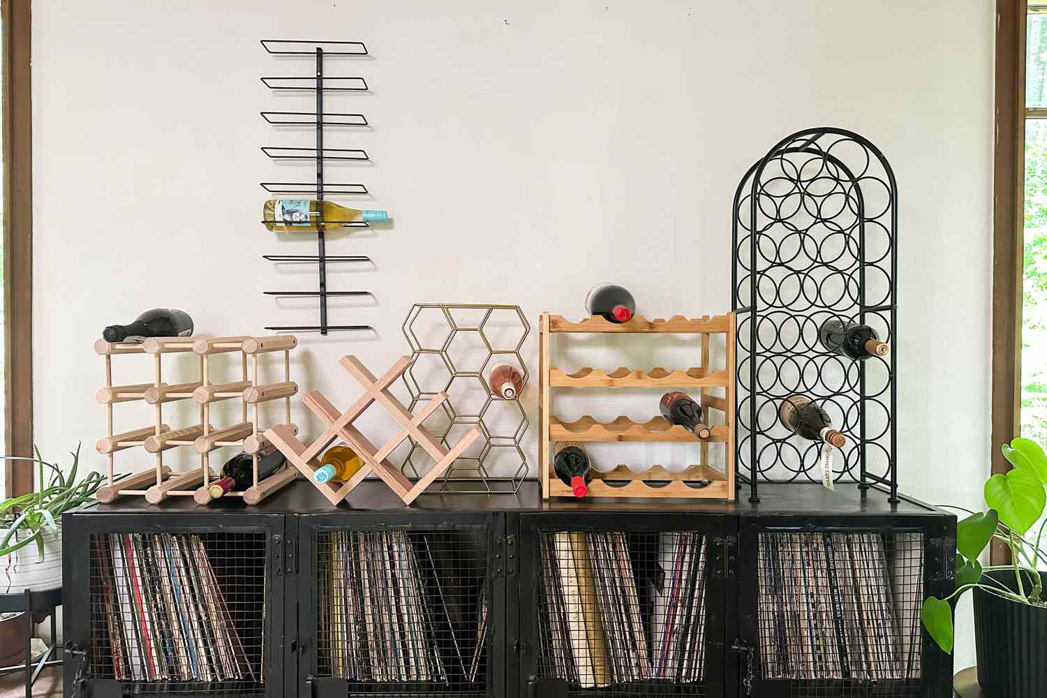 A variety of wine racks displayed on top of a record player