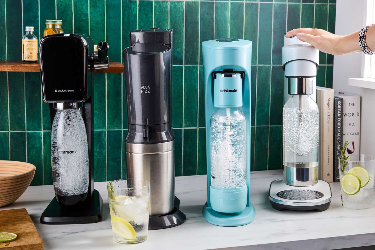 Four soda makers on a kitchen countertop.