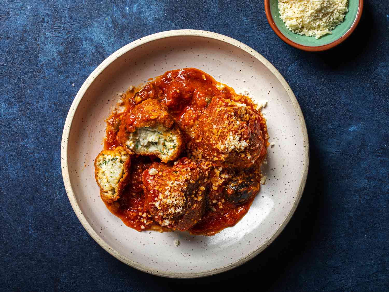 Overhead view of albondigas de ricotta on a blue background