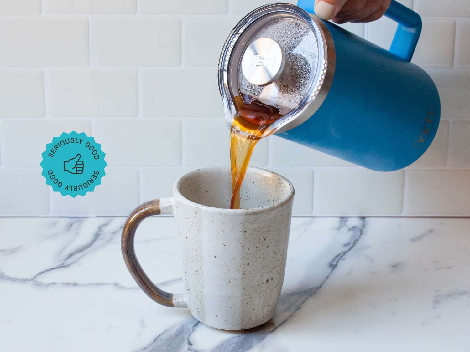 Coffee being poured from the Yeti french press into a mug.