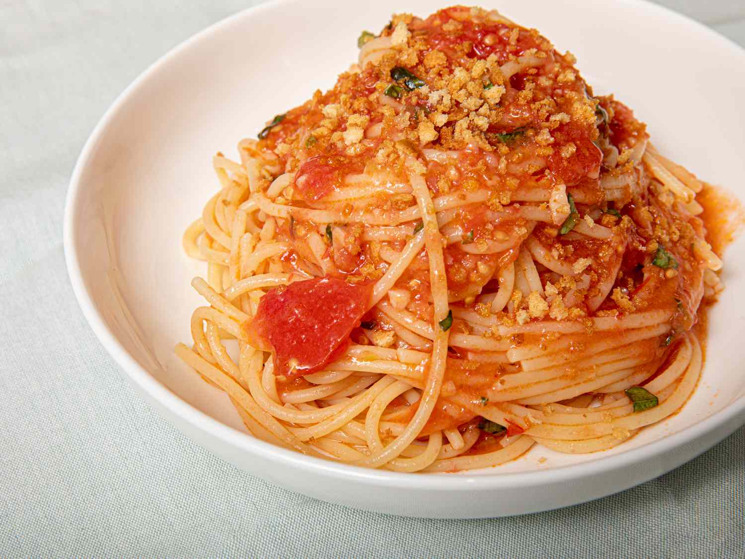 A plate of Sicilian spaghetti alla carrettiera made with fresh tomatoes.