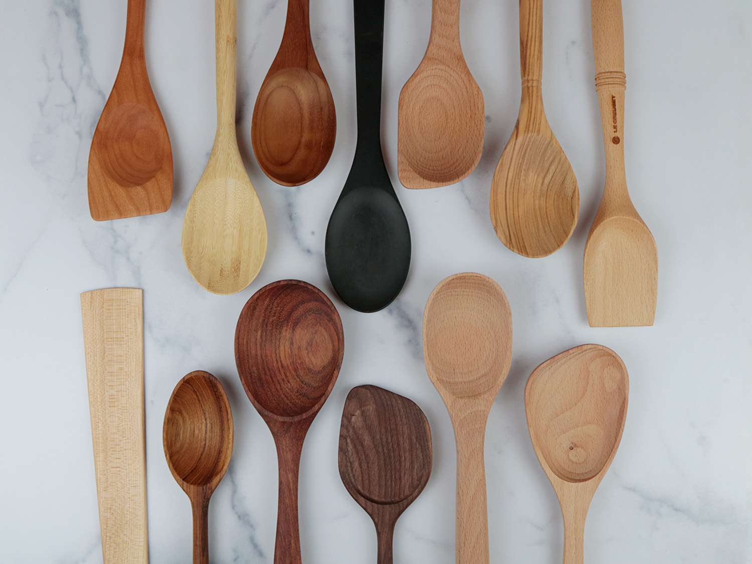 Assortment of wooden spoons on a marble surface