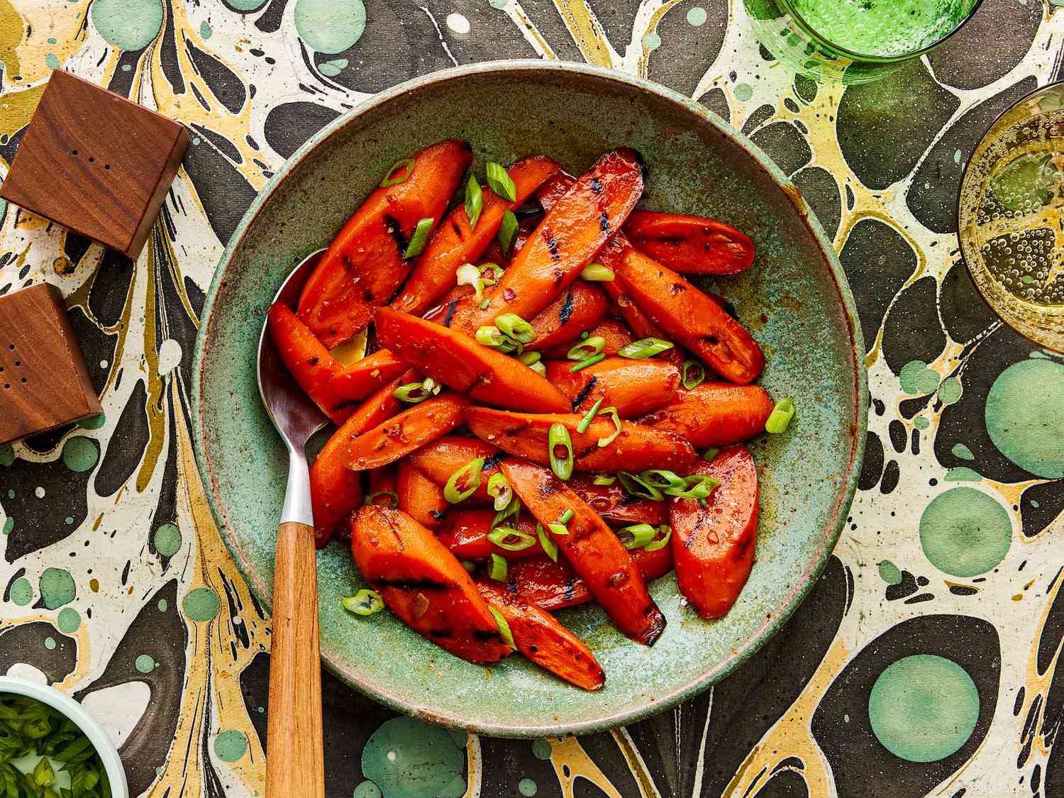 Overhead view of glazed carrots on a funky marble background