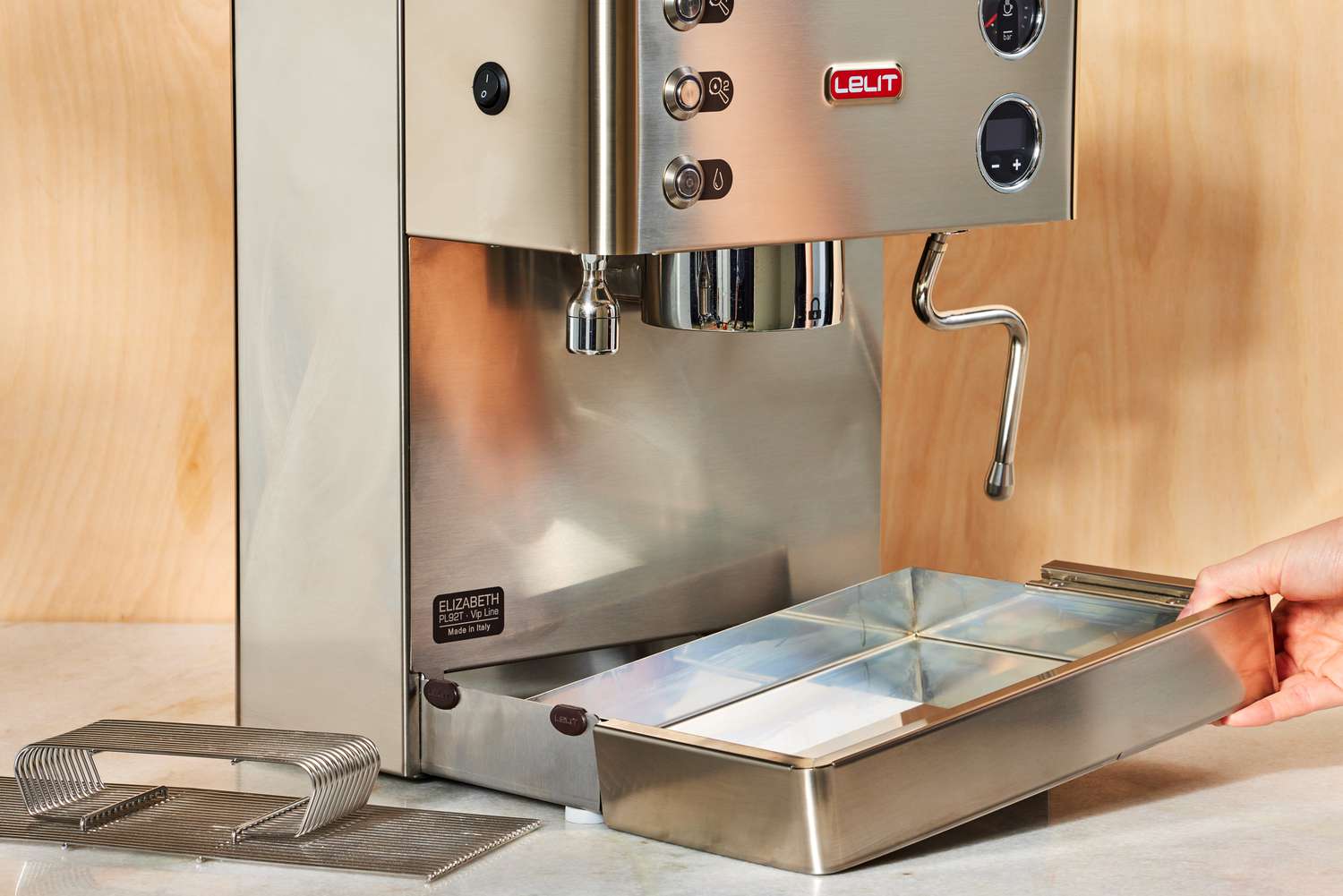 A person lifting up the tray of the Lelit Elizabeth Espresso Machine