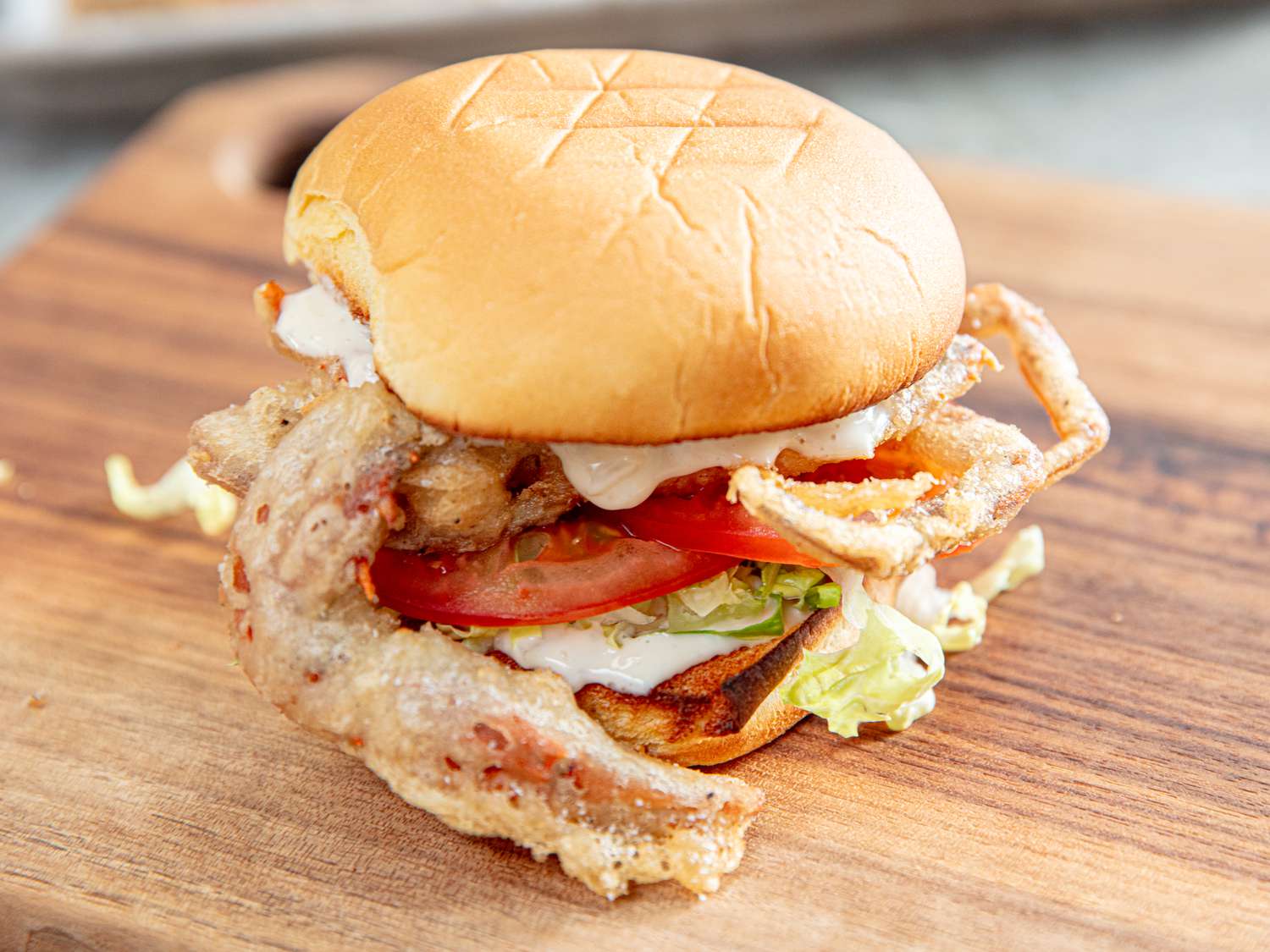 Side view of a fried soft shell crab sandwich