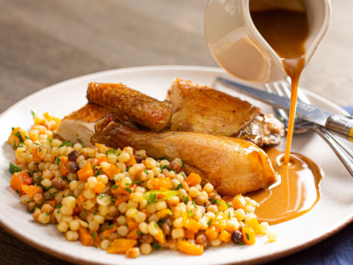 Roast chicken with grains on a plate.