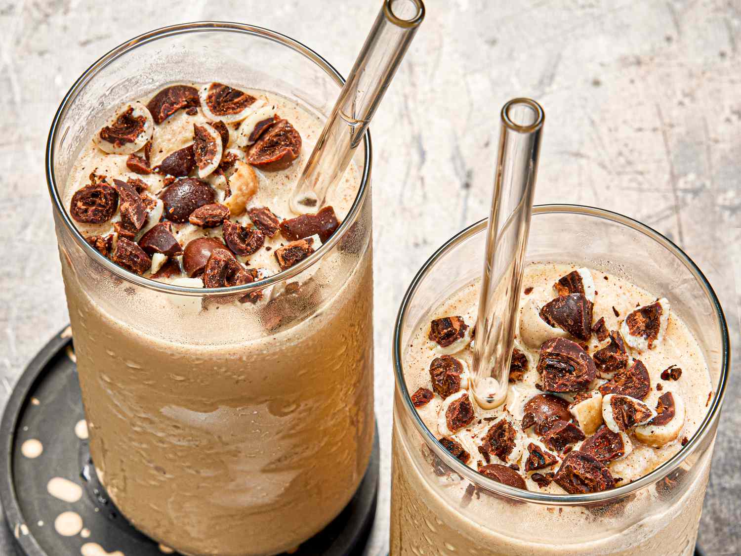 Overhead view of two coffee smoothies with glass straws