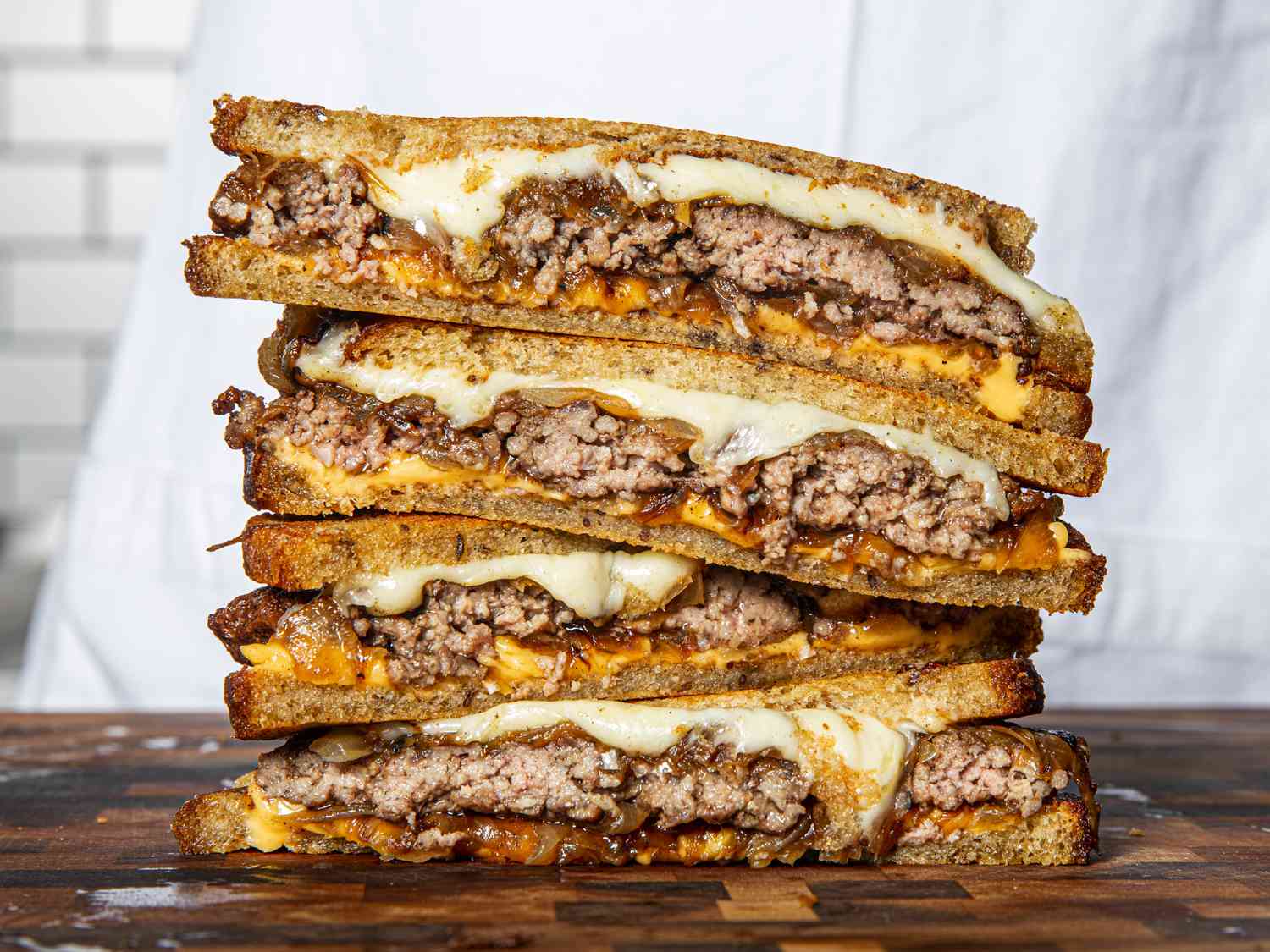 Stacked and sliced-in-half patty melts.