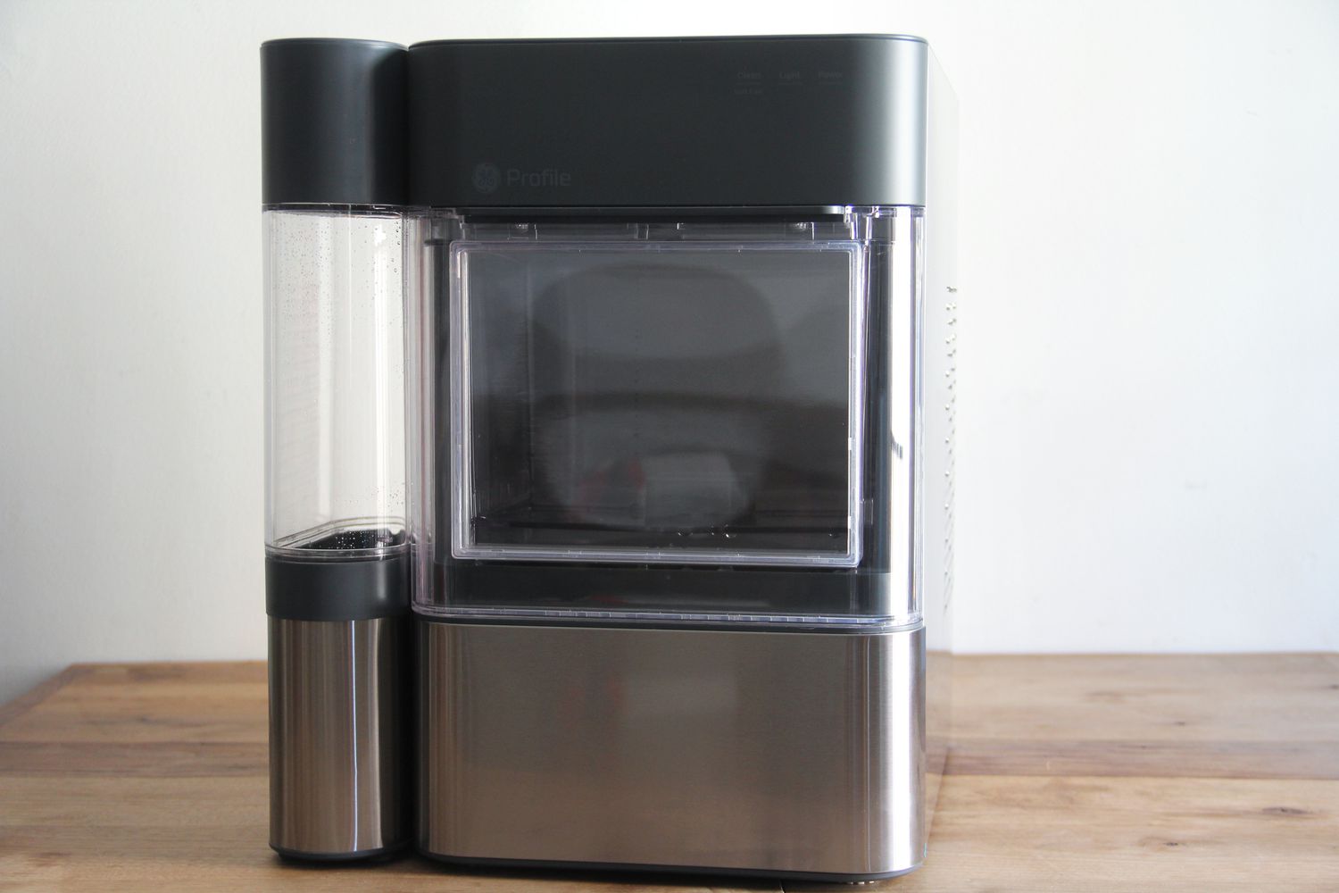 GE ice machine on a wooden counter top. 