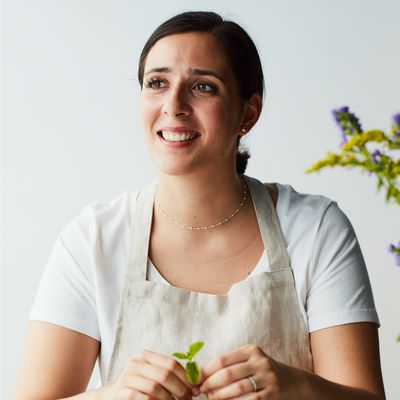 Headshot of Nargisse Benkabbou holding some herbs.