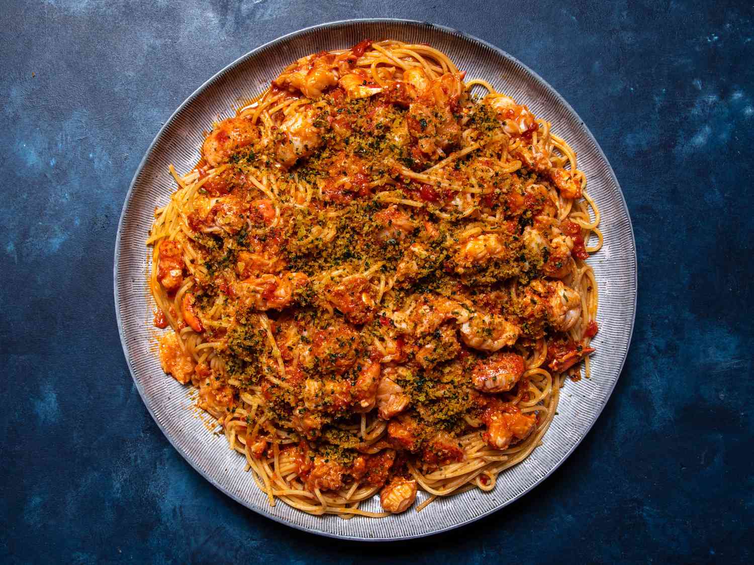 The pasta on a large serving platter, sprinkled with parsley-flecked breadcrumbs.