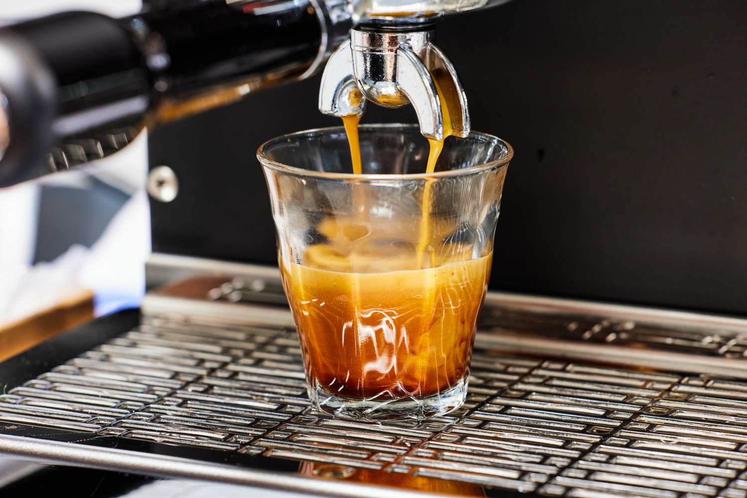 Closeup of the Diletta Mio Espresso Machine brewing an espresso into a glass