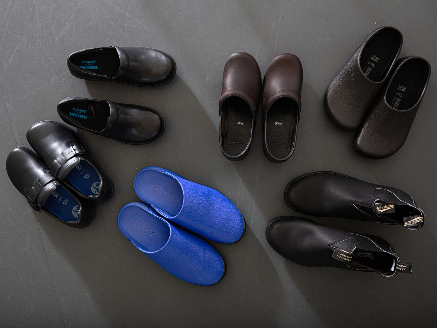 A group of kitchen shoes, including clogs and boots.