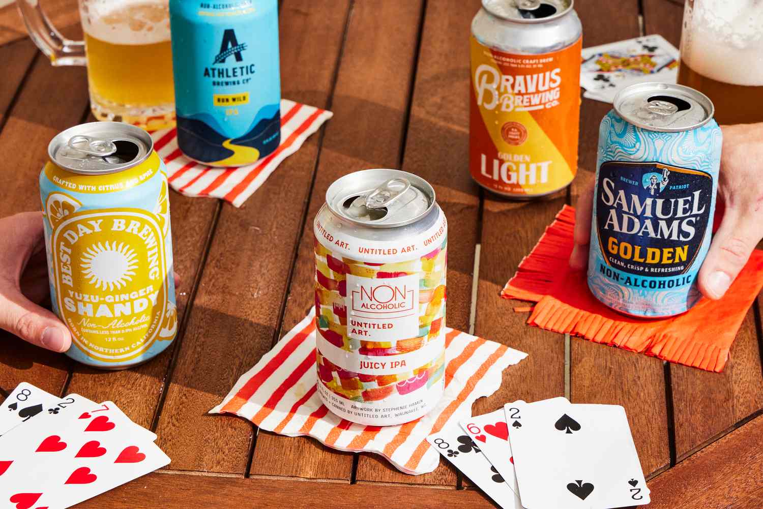 a variety of non alcoholic beers on a table with napkins and cards