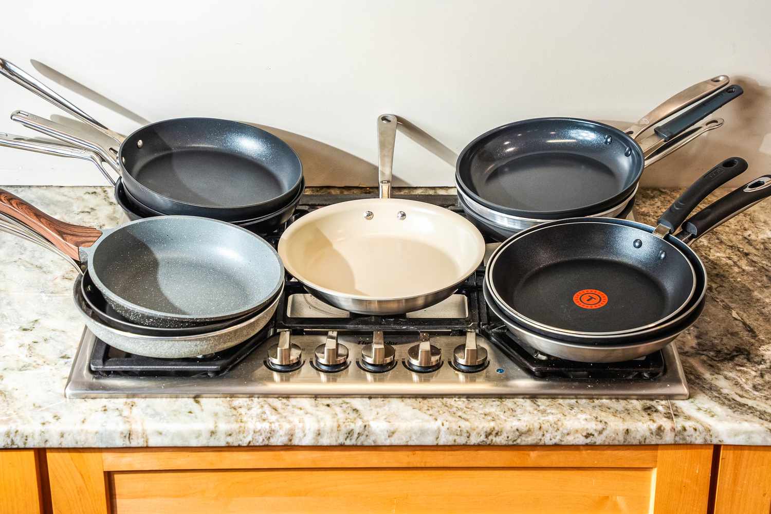 A bunch of pans stacked on a gas stove