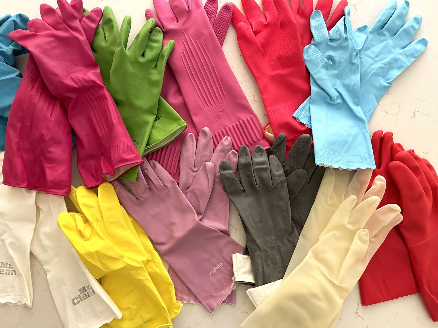 A collection of colorful dish gloves on a counter