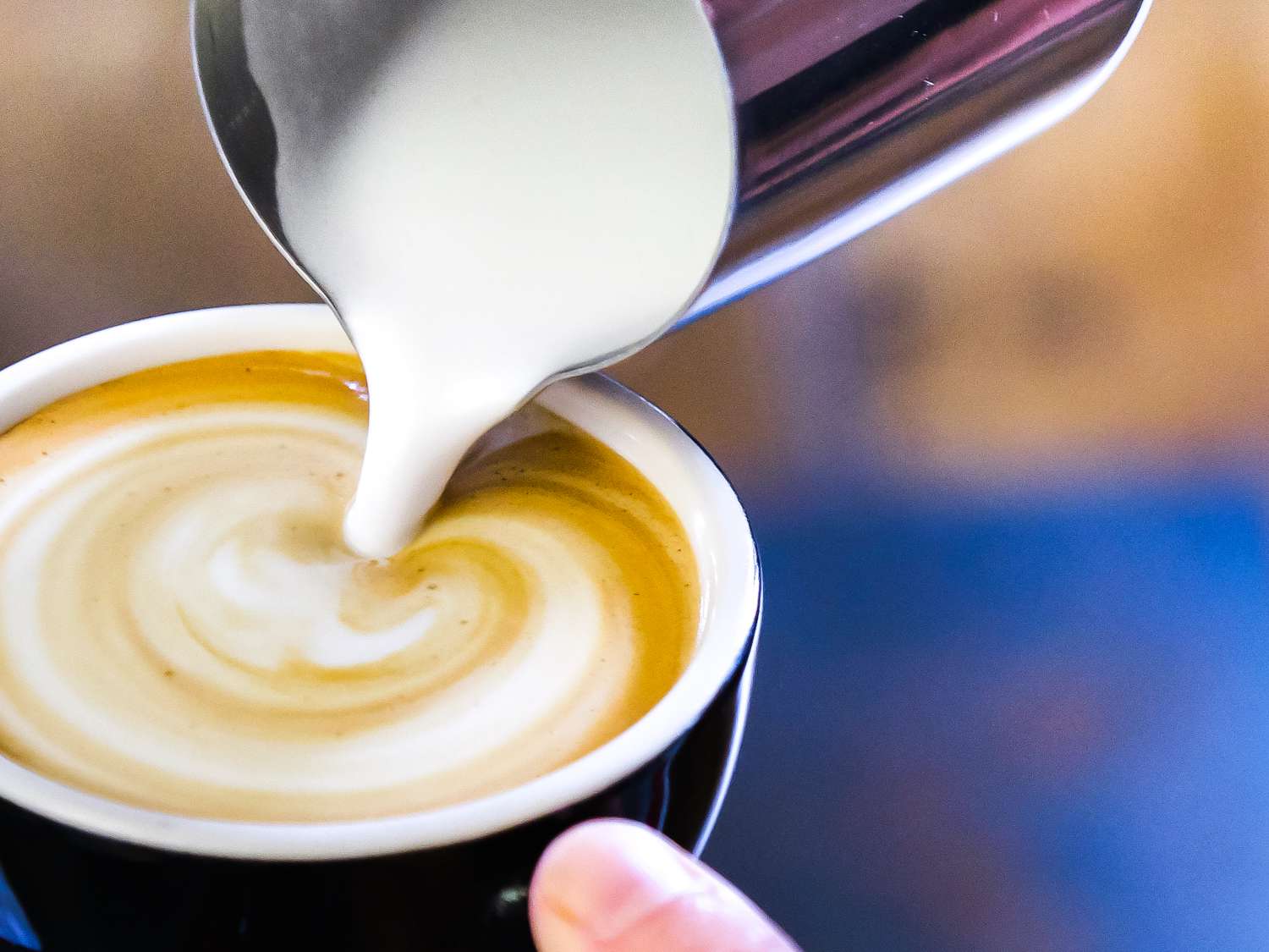 A close up of a latte being made with a non-dairy milk.