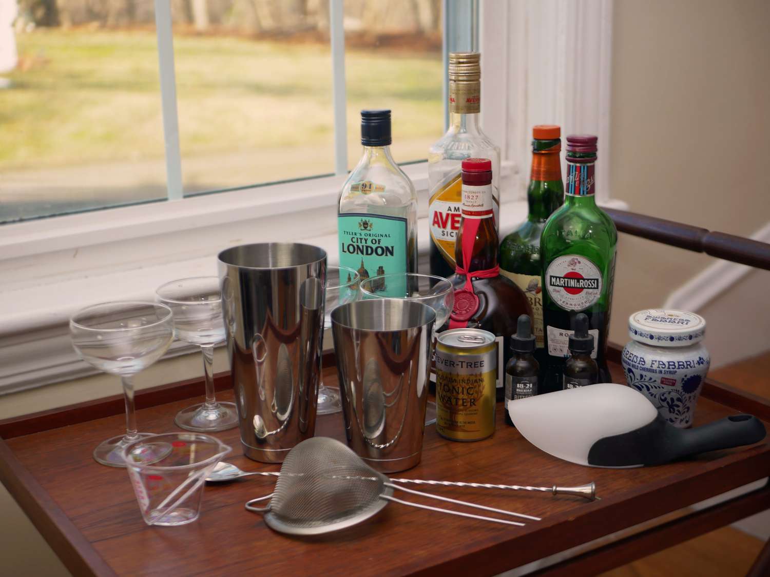 a bar cart with gear and bottles of liquor on it