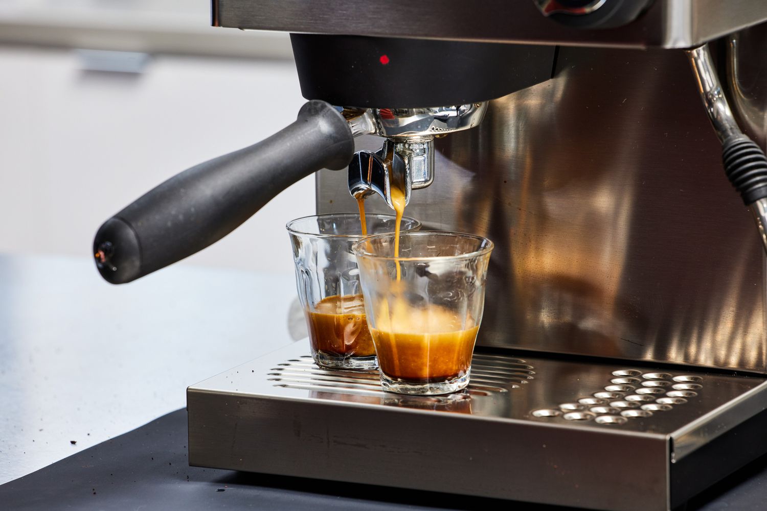 Closeup of the Rancilio Silvia Espresso Machine brewing two espressos into glasses