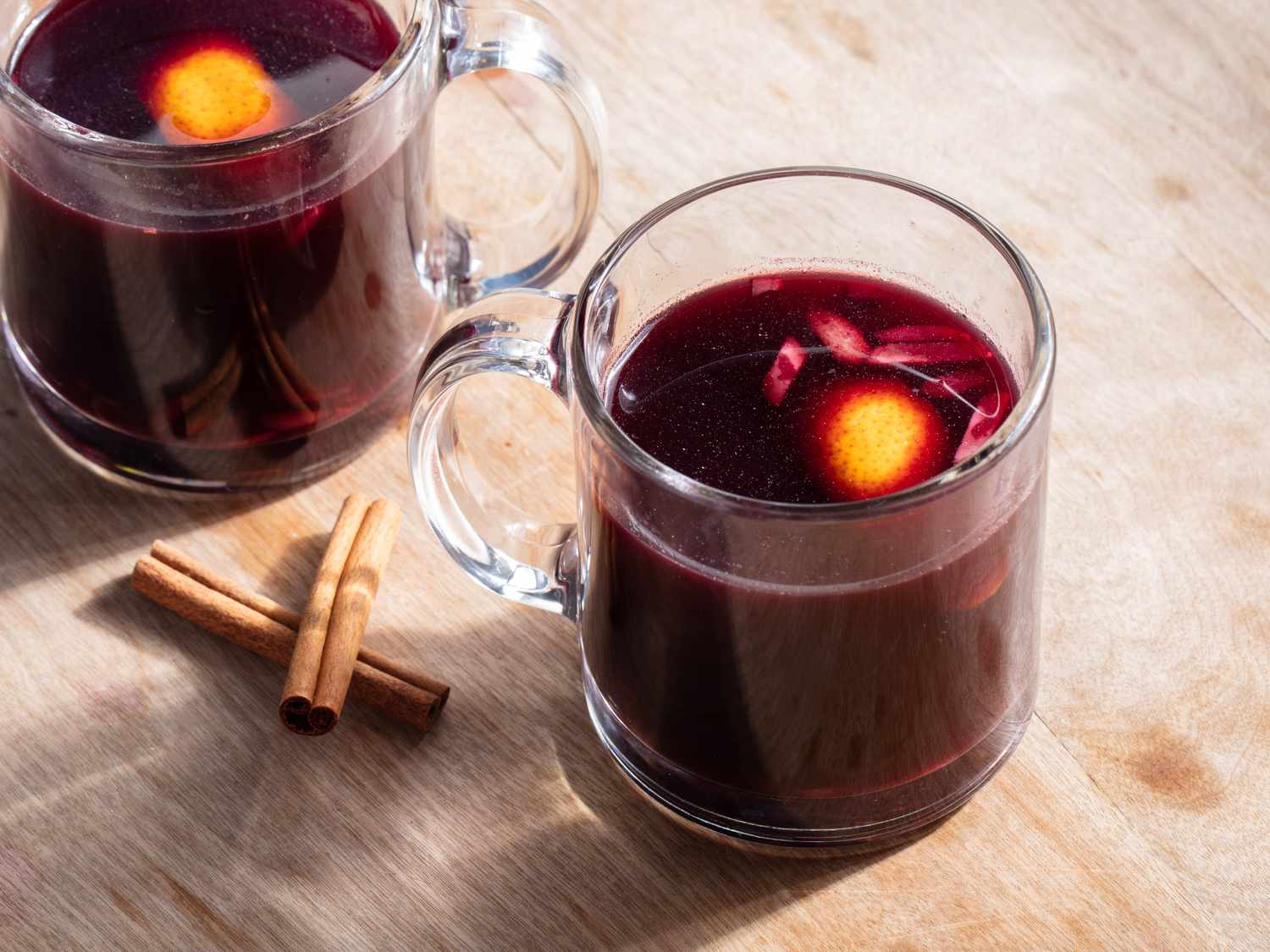 Glogg in two glass mugs on a wooden table