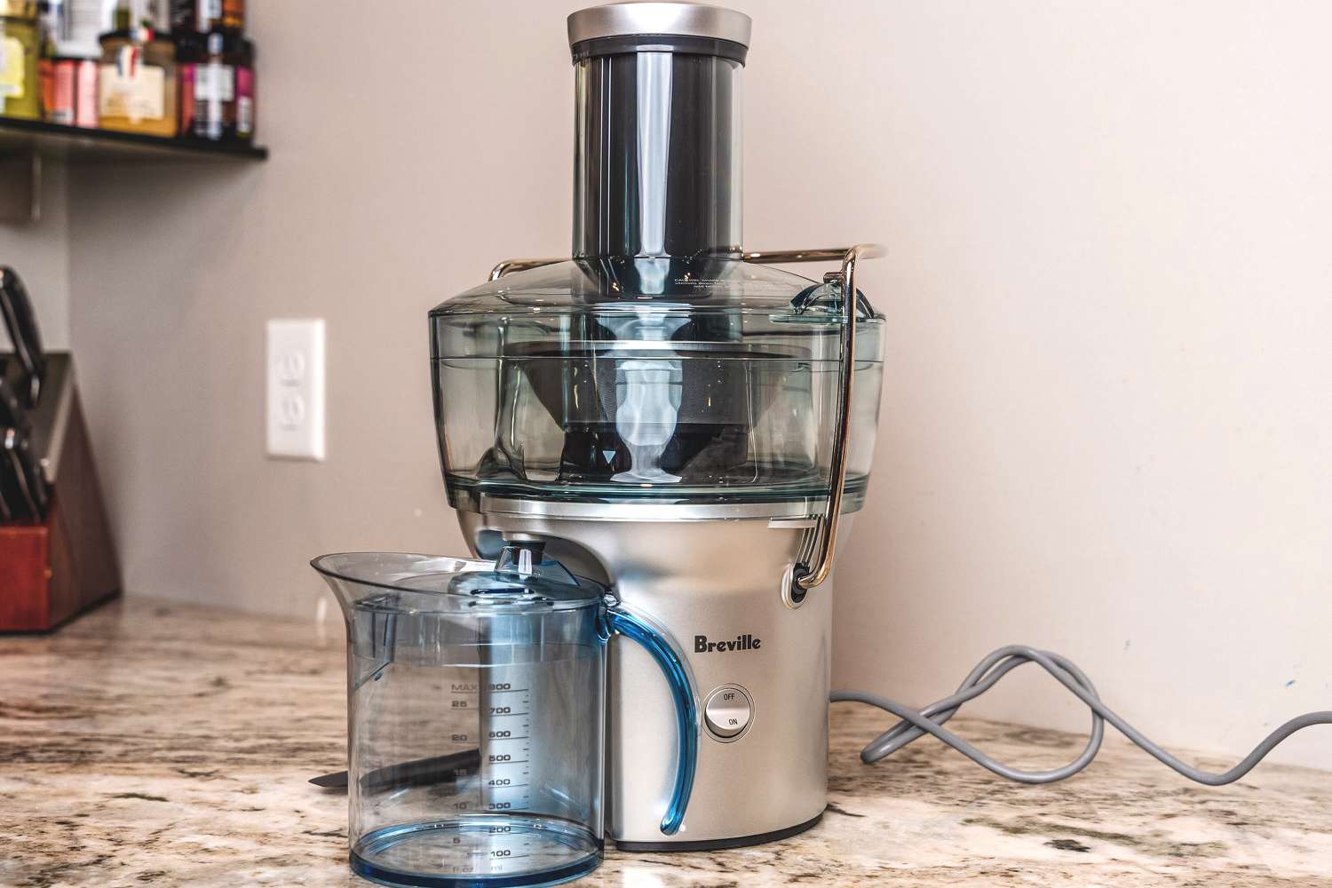 A Breville juicer on a kitchen countertop.