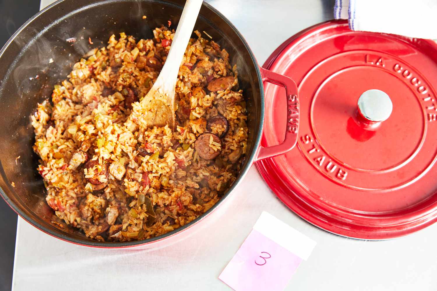 a red staud Dutch oven with jambalaya in it