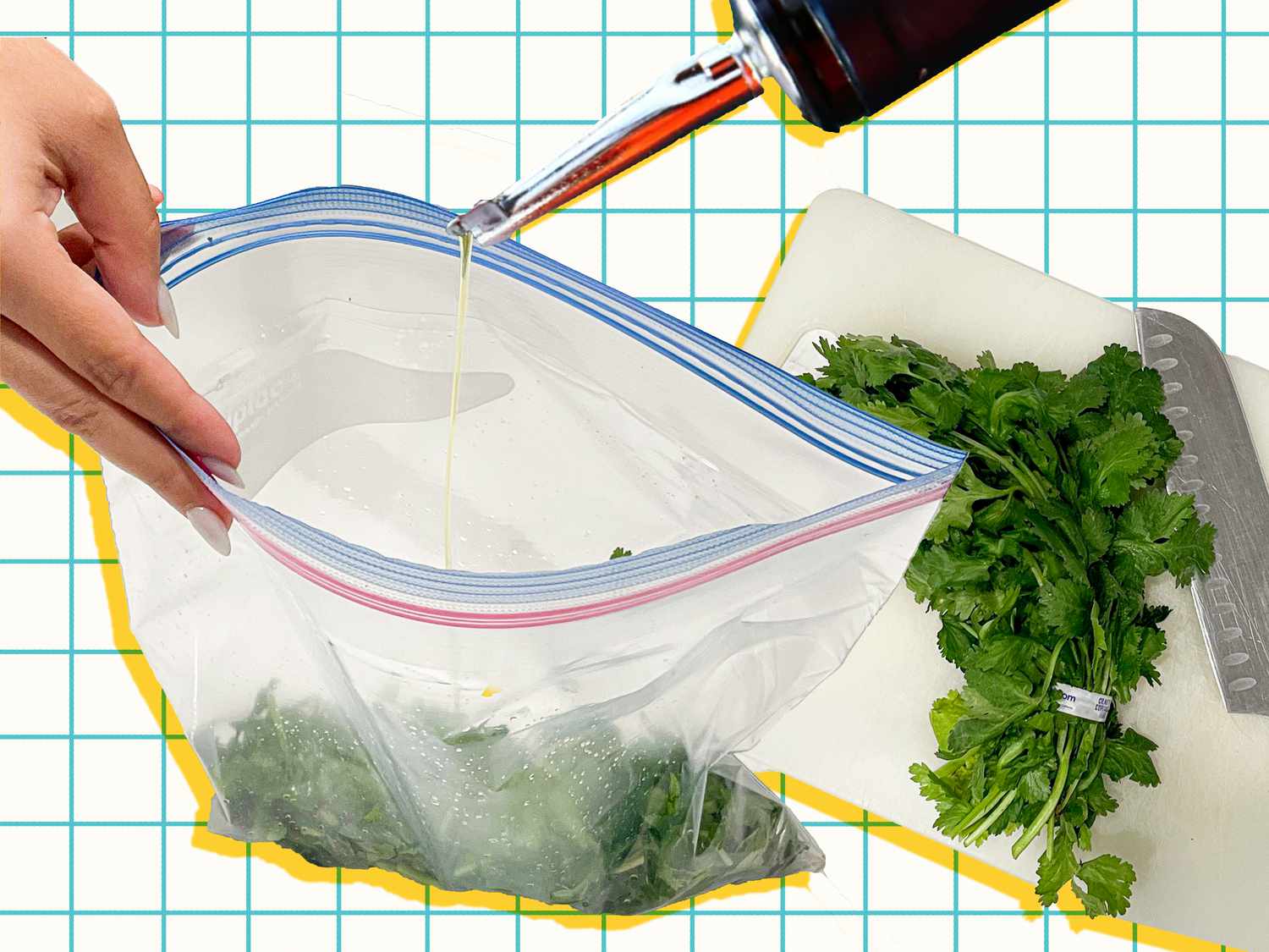 Herb s in a bag being drizzled with olive oil next to a cutting board with a bunch of herbs and a knife. 