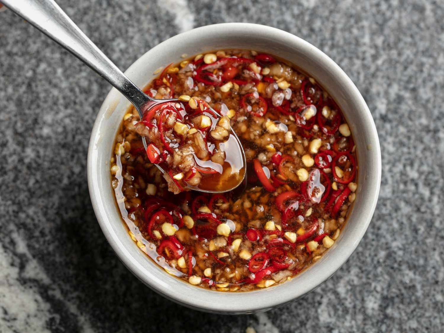 Thai-style sweet chili dipping sauce in a bowl with a spoon